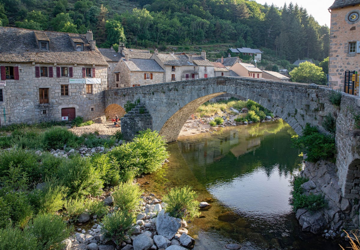 An old stone bridge spans a river at Le Pont de Montvert