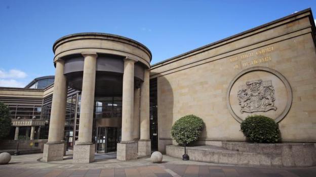 High Court in Glasgow is a sandstone building with columns by the entrance and a crest on the wall