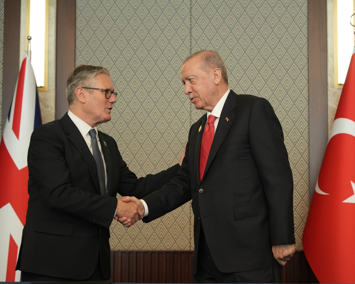Britain's prime minister Keir Starmer, left, shakes hands with Turkish President Recep Tayyip Erdoğan during a meeting on the sidelines of the Nato summit.