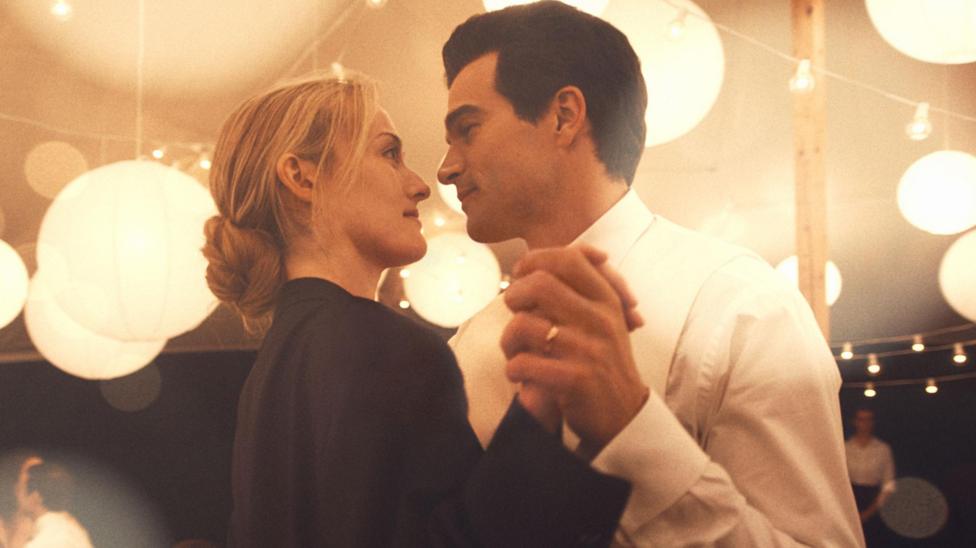 Sarah Pidgeon as Carolyn Bessette Kennedy dancing with Paul Kelly as John F Kennedy Jr in a still from Love Story