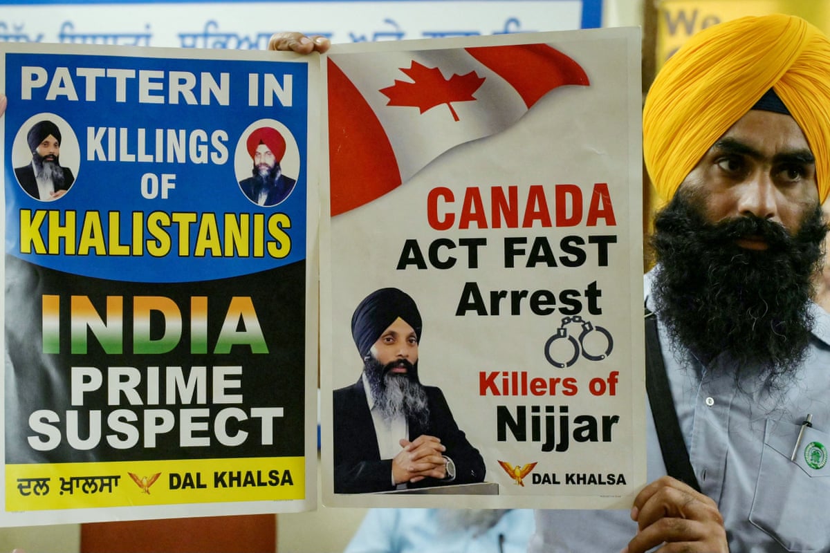 A member of a Sikh organisation holds a placard showing Hardeep Singh Nijjar in Amritsar in September 2023.
