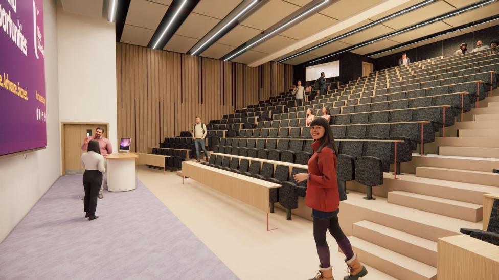 An architect's impression of the new centre's teaching and seminar space. It shows rows of tiers seating facing a board. A number of people are standing in the foregorund