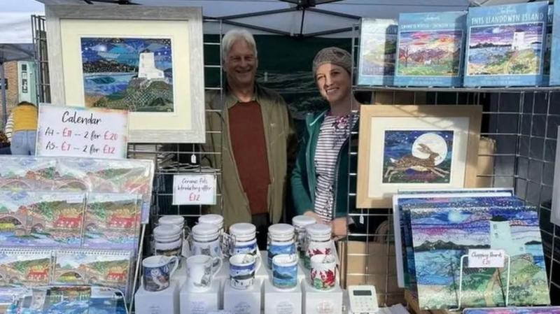 Shaun Russell stood with his daughter Josie at a stall selling her art works. 