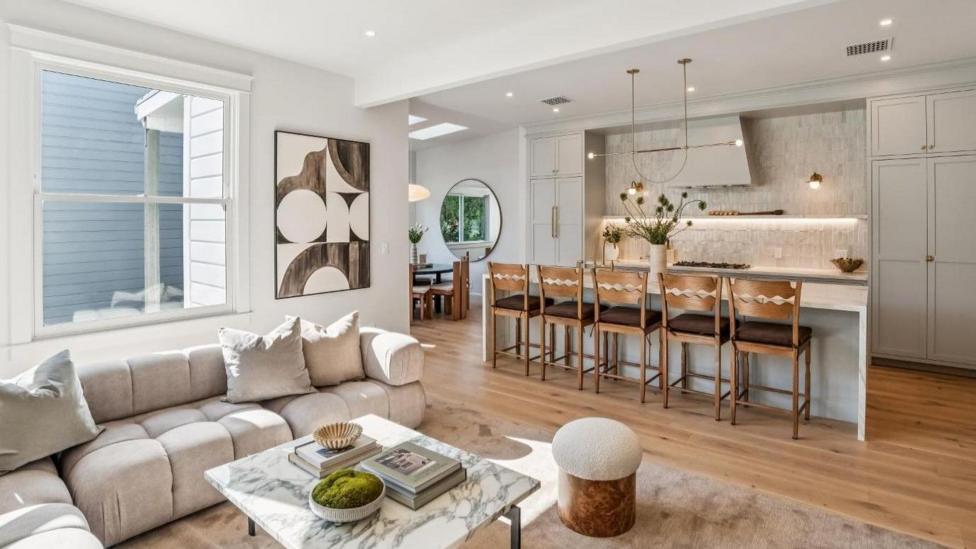 The lounge and dining area of the apartment in San Francisco, with a sofa area and dining tables