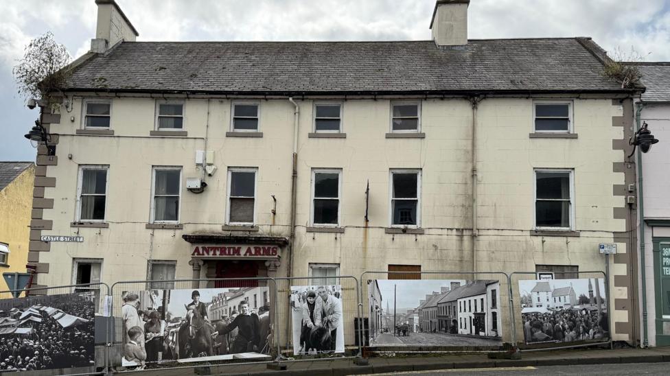 The former Antrim Arms hotel in Ballycastle town centre in September 2025. The large cream-coloured building has six front windows on each of its three floors and the sign above the front door says 