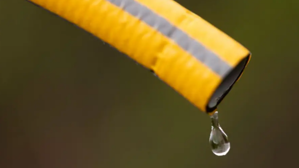 Generic image of a water droplet coming from a yellow hose.