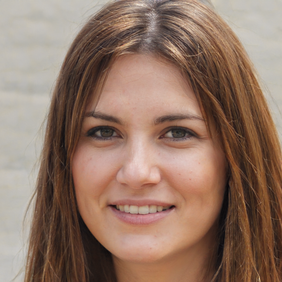 A young woman with shoulder length brown hair smiling at the camera