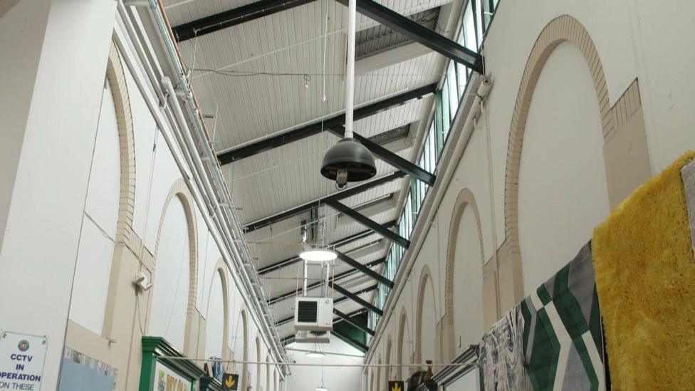 The ceiling of Smithfield Market showing four lights with one broken