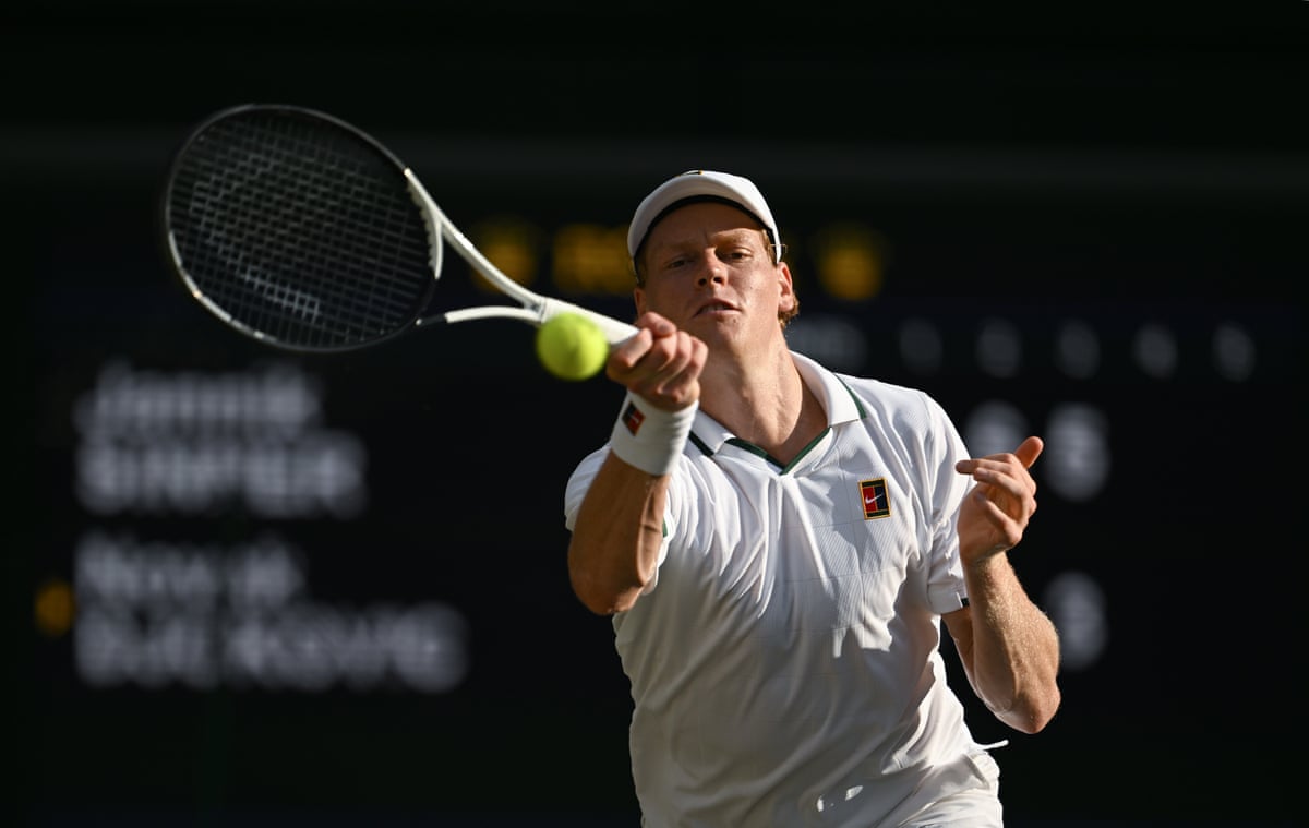 Jannik Sinner stretches to hit a return