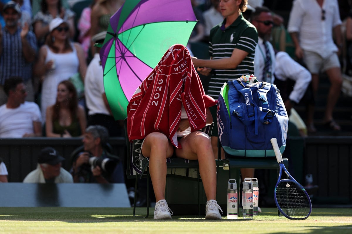 Linda Noskova sits with a towel over head at a change of ends
