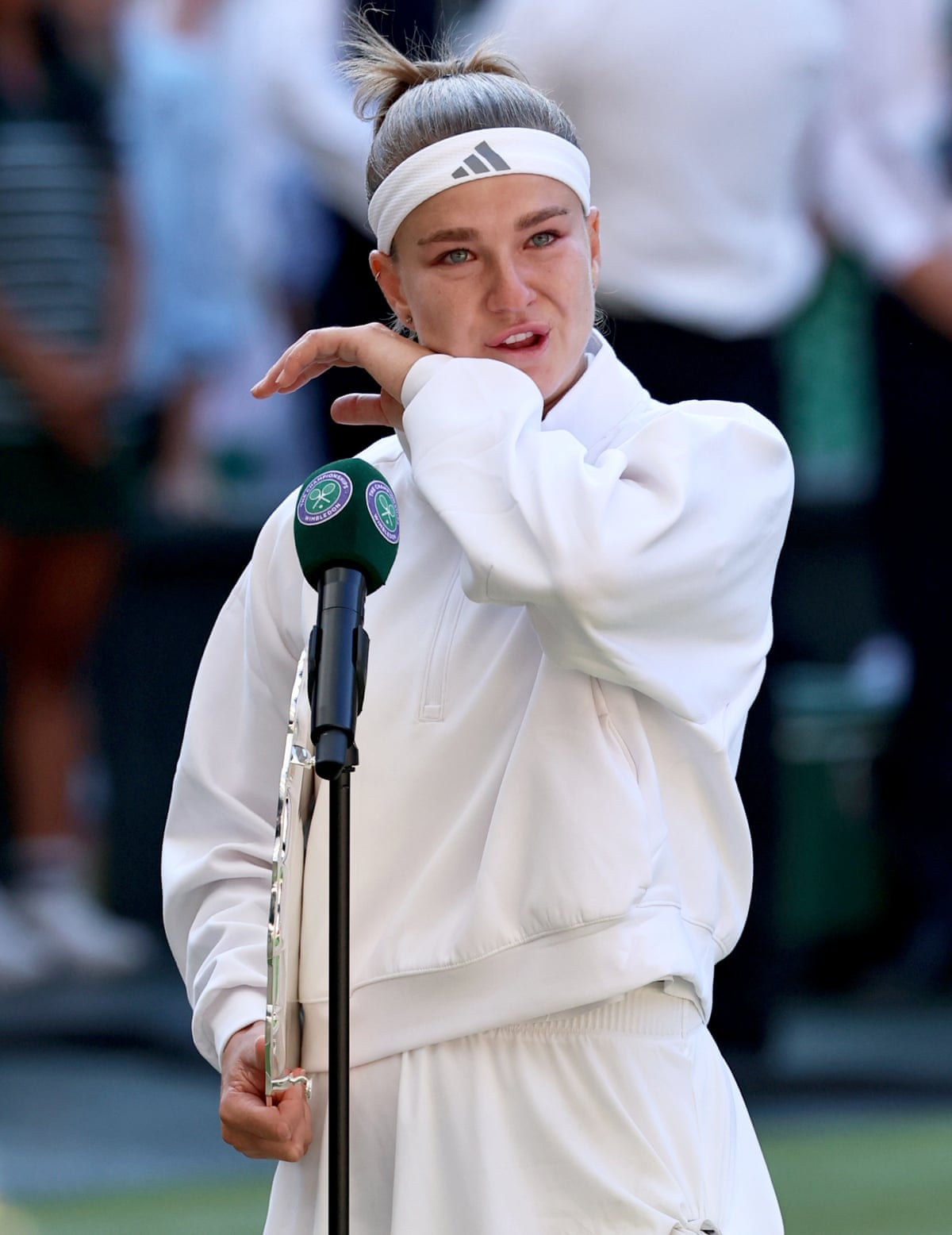 Karolina Muchova stands at the on-court microphone