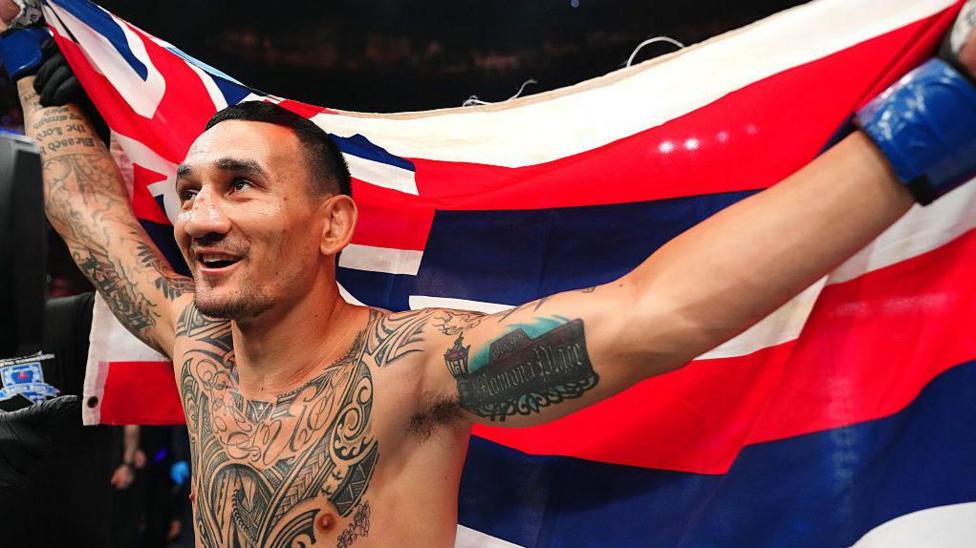 Max Holloway holds a flag