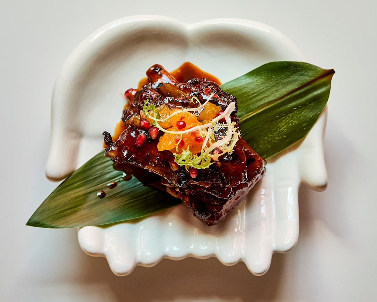 Kawan’s choco-orange ribs arranged on a leaf on a bowl shaped like cupped palms
