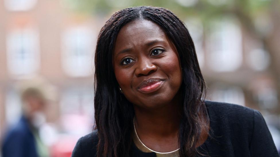 Miatta Fahnbulleh seen smiling outdoors whilst wearing a black blazer.