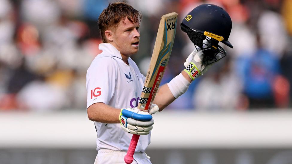 Ollie Pope raises his bat after reaching his century in Hyderabad in 2024