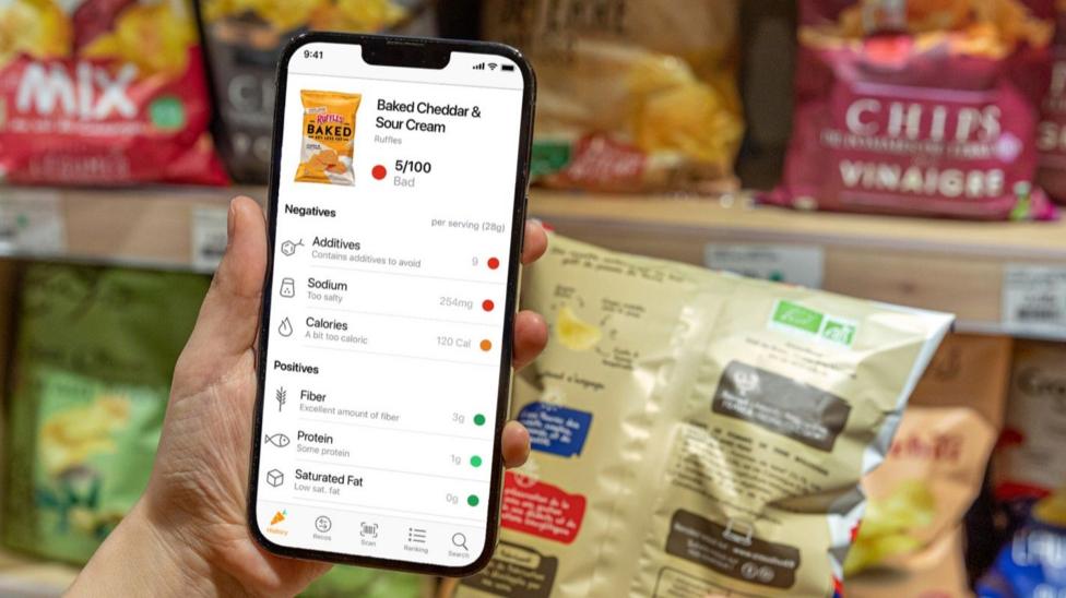 Someone scans a bag of crisps using the Yuka app