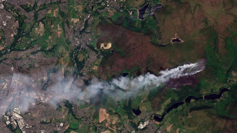 Satellite image showing smoke plume drifting west