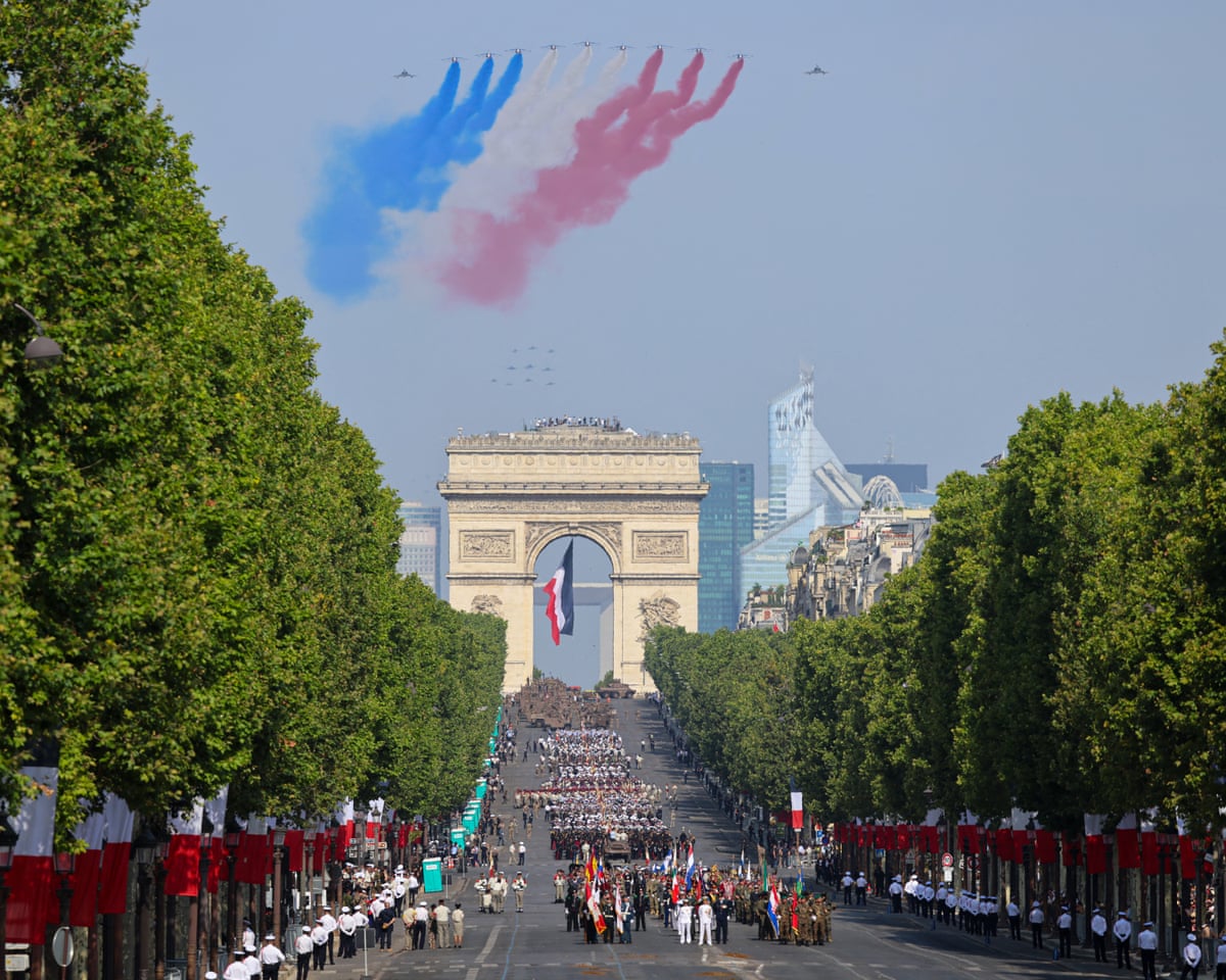 France’s Air Force Elite aerobatic flying team “Patrouille de France” (PAF) releases trails of France’s national colours as they perform a flyover during the annual Bastille Day military parade.