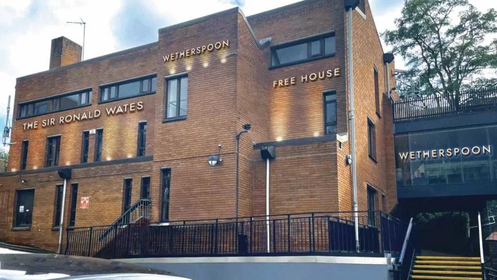A brown brick building. It says Wetherspoon on the outside.