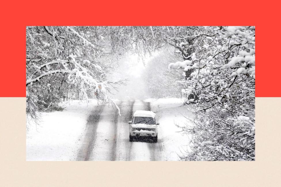 A vehicle is driven along a snow covered road in Scotton, Harrogate, North Yorkshire.