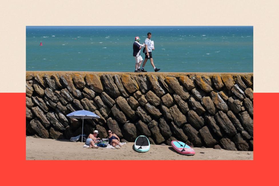 People experiencing the hot weather on Sunny Sands beach in Folkestone, Kent.