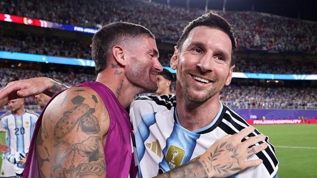 Rodrigo de Paul celebrating with Lionel Messi for Argentina