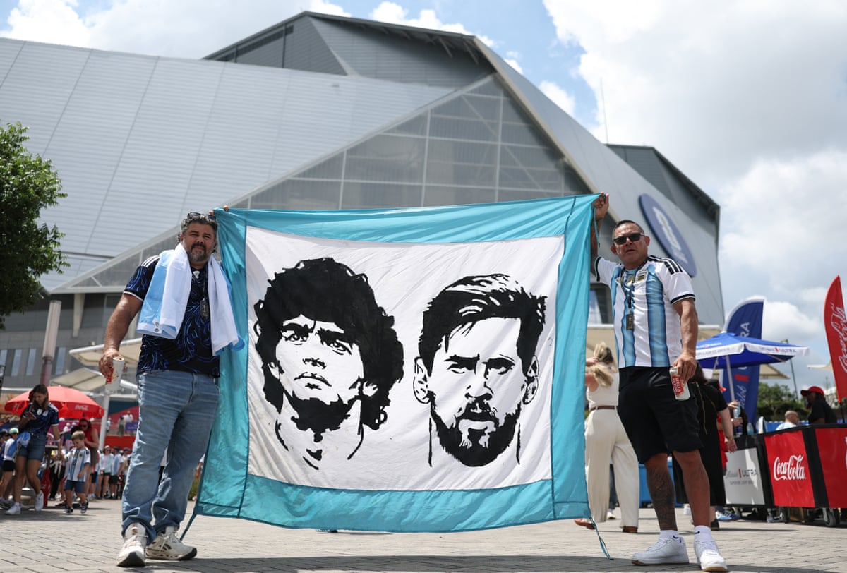 Argentina fans display a Diego Maradona and Lionel Messi flag