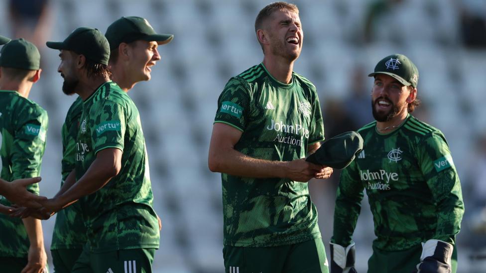 Olly Stone, wearing Notts Outlaws' green shirt, celebrates with his team-mates after beating Surrey.