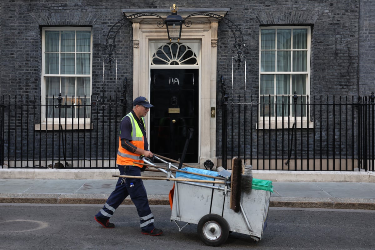 A man cleaning the street in Downing Street this morning.