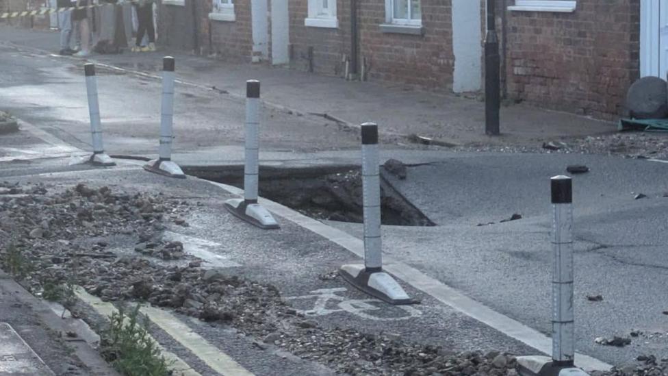 A photo of the tarmac having sunk into the ground