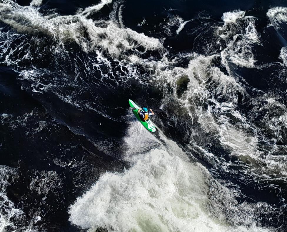 A kayaker navigating powerful white-water rapids.