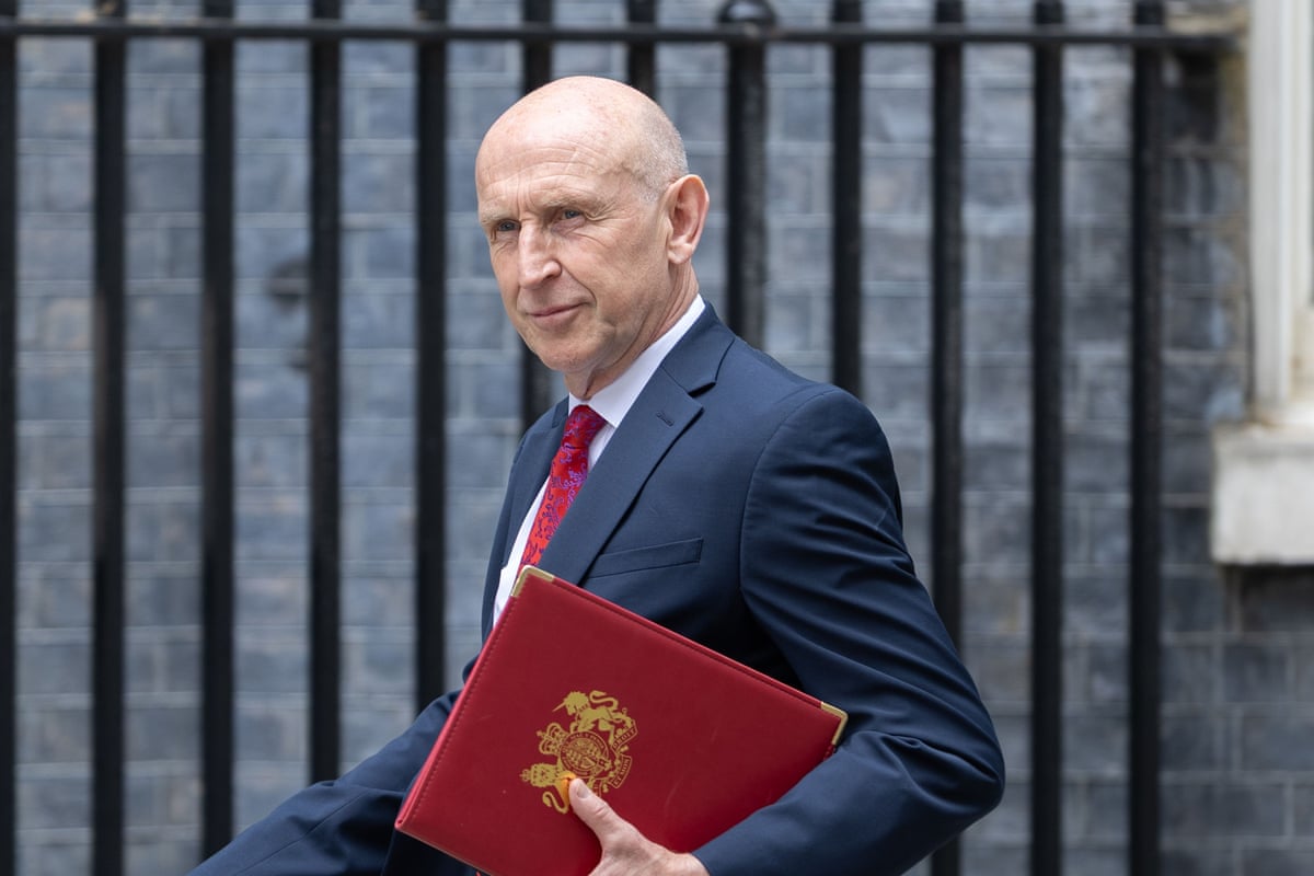 John Healey arrives for the first cabinet meeting in Downing Street, London.