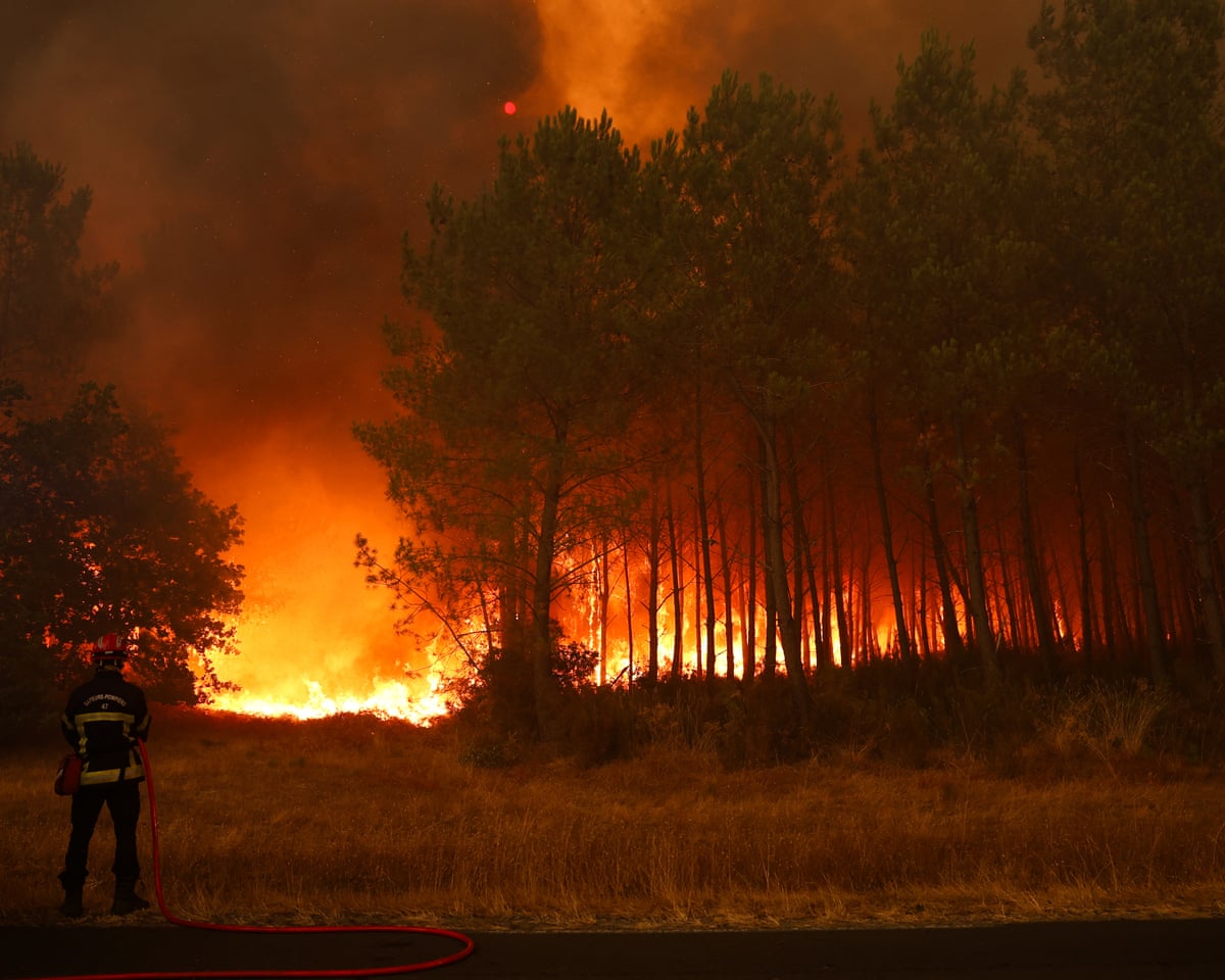 Firefighters battle the blaze using a water truck near the village of Le Porge in south-western France.
