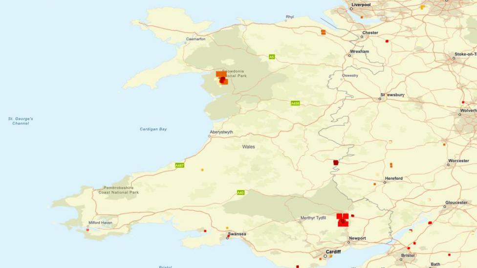 A data map of Wales. The country is depicted in pale yellow and green; the heat signatures are indicated by squares of orange and red. 