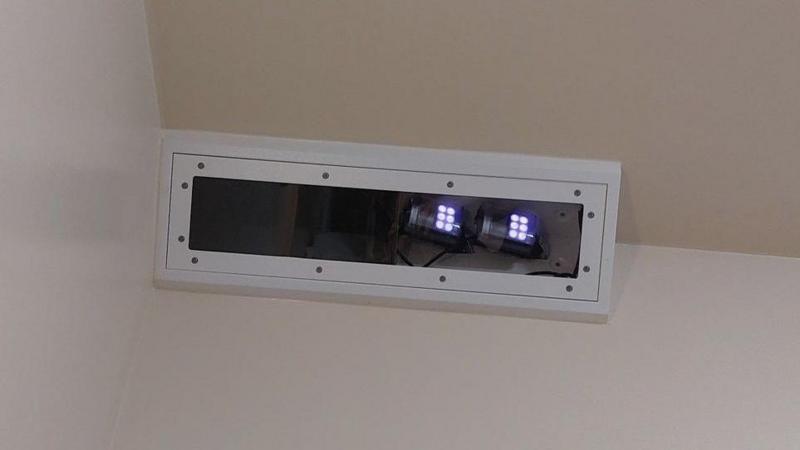 A box on a wall with lights on, which is a digital monitoring system.