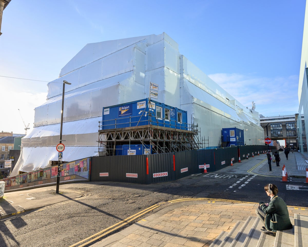 The Mackintosh building in 2024, covered in white plastic sheeting.