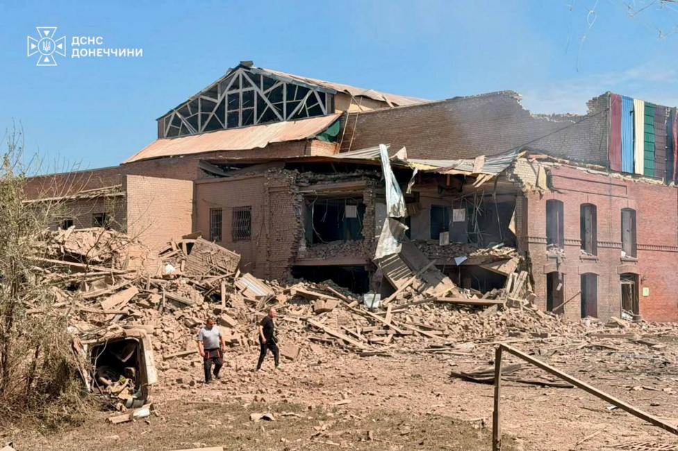 The damage to a building and a pile of rubble at the scene of a Russian missile strike just outside of Kyiv