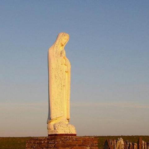A statue of the Virgin Mary in the evening sun light