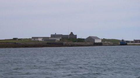 A collection of buildings on an island. 