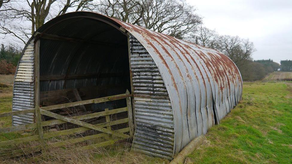 A corrugated iron semi-circular building