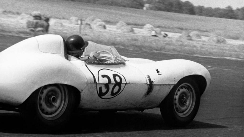 Scottish racing legend Jim Clark takes a bend in a car numbered 38 in a black and white picture