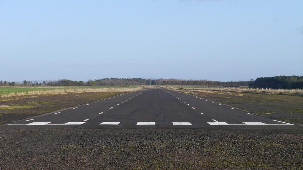 A view across an airfield with a runway 