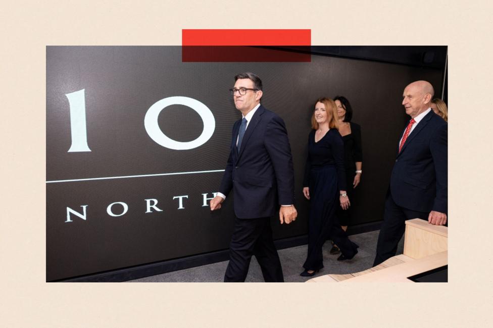 Britain's Prime Minister Andy Burnham walking past a sign which says 10 North