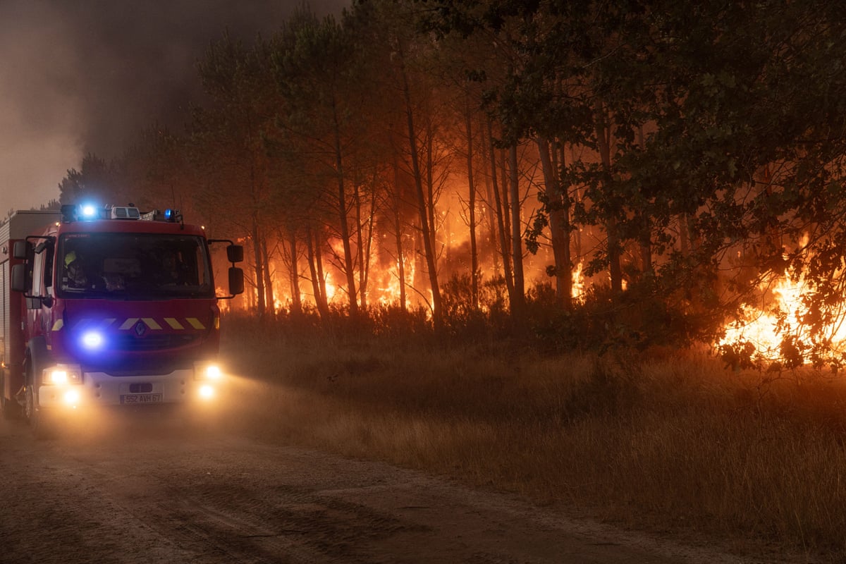 Firefighters arrive at the scene to tackle a flare-up and limit its spread through the woodland in L'Ombrière, Saint-Jean-d'Illac, Gironde, France.