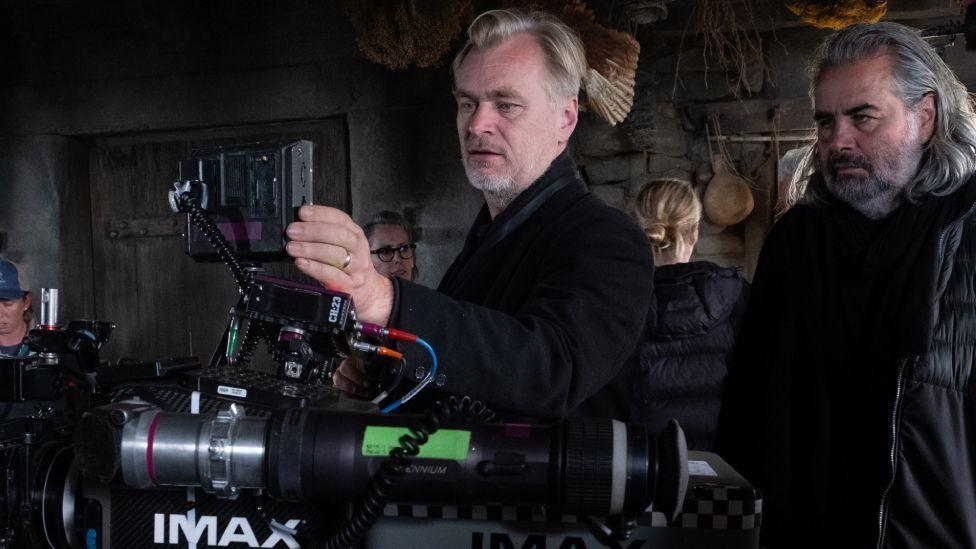 Director Christopher Nolan pictured with an IMAX camera on the set of The Odyssey
