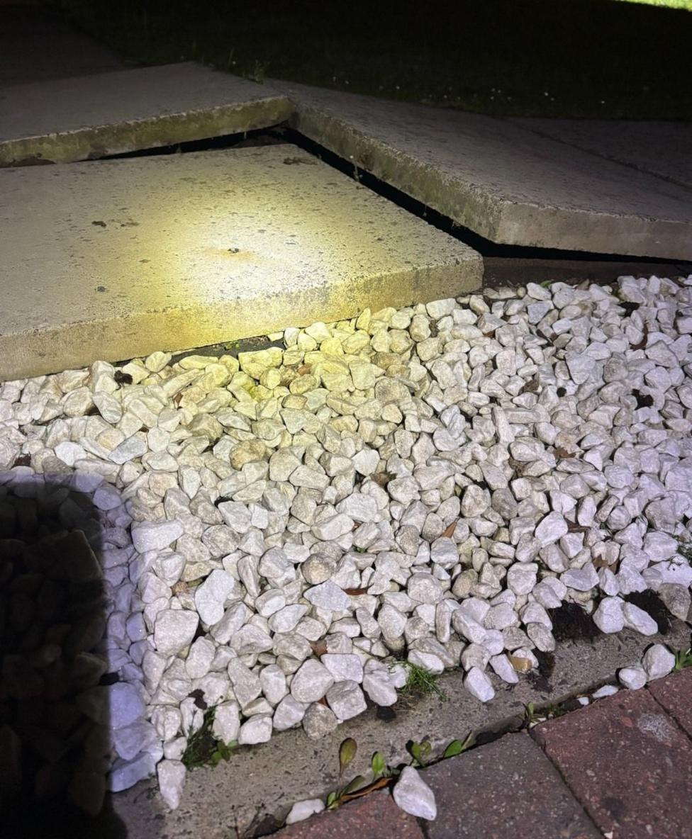 Raised flagstones with small stone chips in front on a doorstep