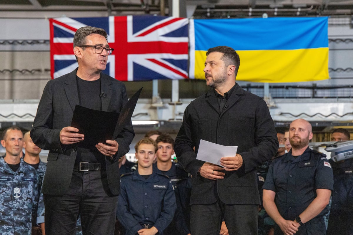 Andy Burnham and Volodymyr Zelenskyy stand in front of their countries’ respective flags at the naval base in Portsmouth.