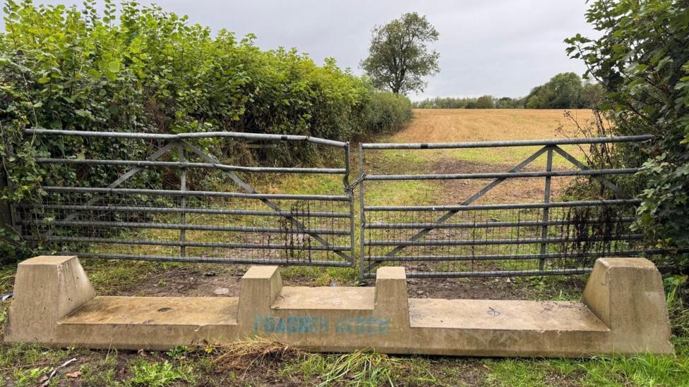 A concrete barrier placed in front of damaged gates to a farmer's fields in the Vale of Glamorgan