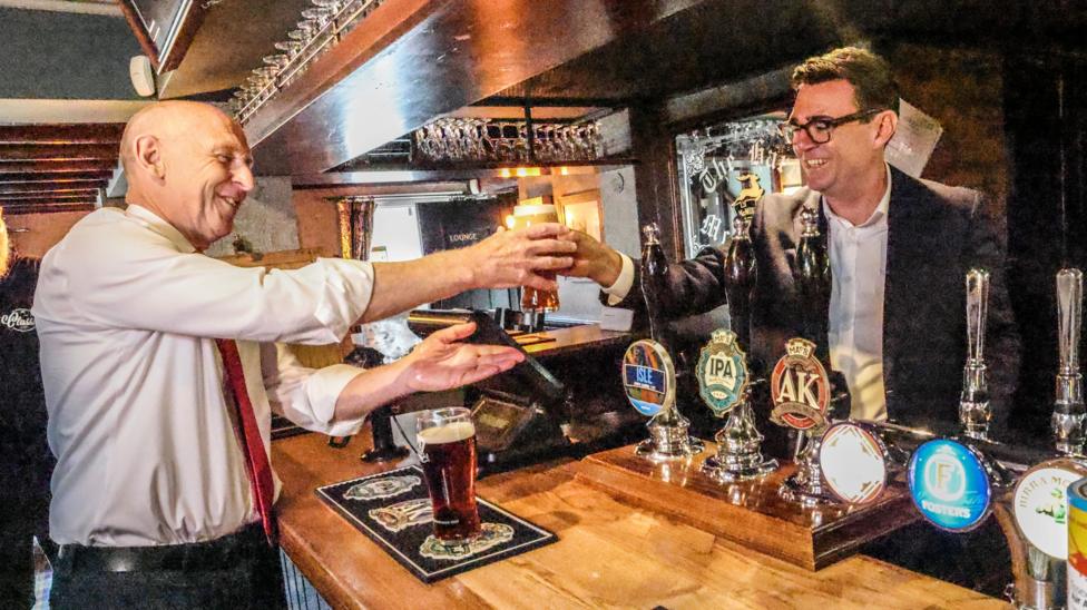 Prime Minister Andy Burnham and Chancellor John Healey in a pub