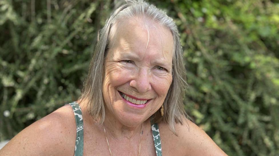 Lizzy Smart, an older woman with a grey bob, smiles at the camera 